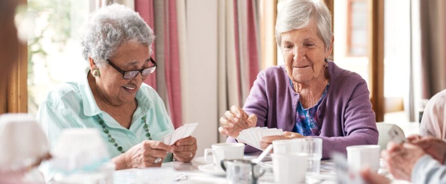 Shot of a group of senior women playing cards together at a retirement home