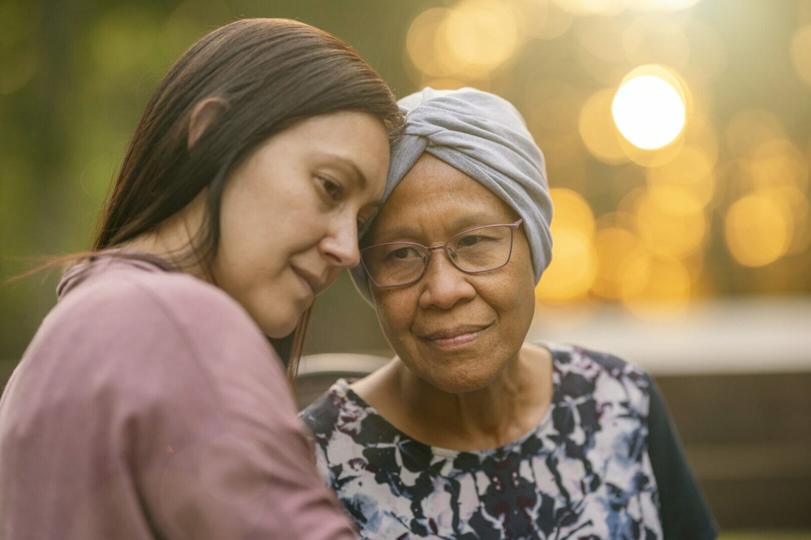 Mixed race woman comforting her ill mother