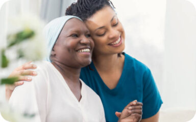 A caregiver embraces a senior resident with warmth and compassion at the living facility.