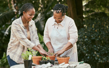 Shot of a mother and daughter gardening together in their backyard