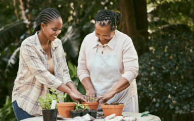 Shot of a mother and daughter gardening together in their backyard