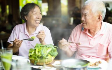 happy Senior Couple Enjoying hot pots In Restaurant