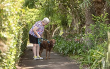 Senior woman walking her dog