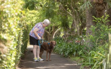 Senior woman walking her dog