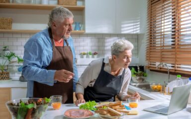 Caucasian family cooking together in kitchen at home.