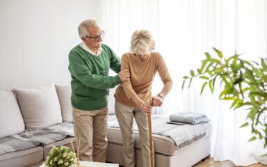 Couple elderly retirement husband helping wife have a back pain