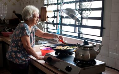 Senior Asian woman preparing food in kitchen