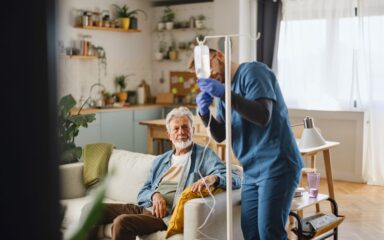 Male caregiver giving an infusion to the patient