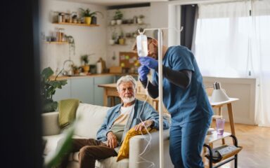 Male caregiver giving an infusion to the patient