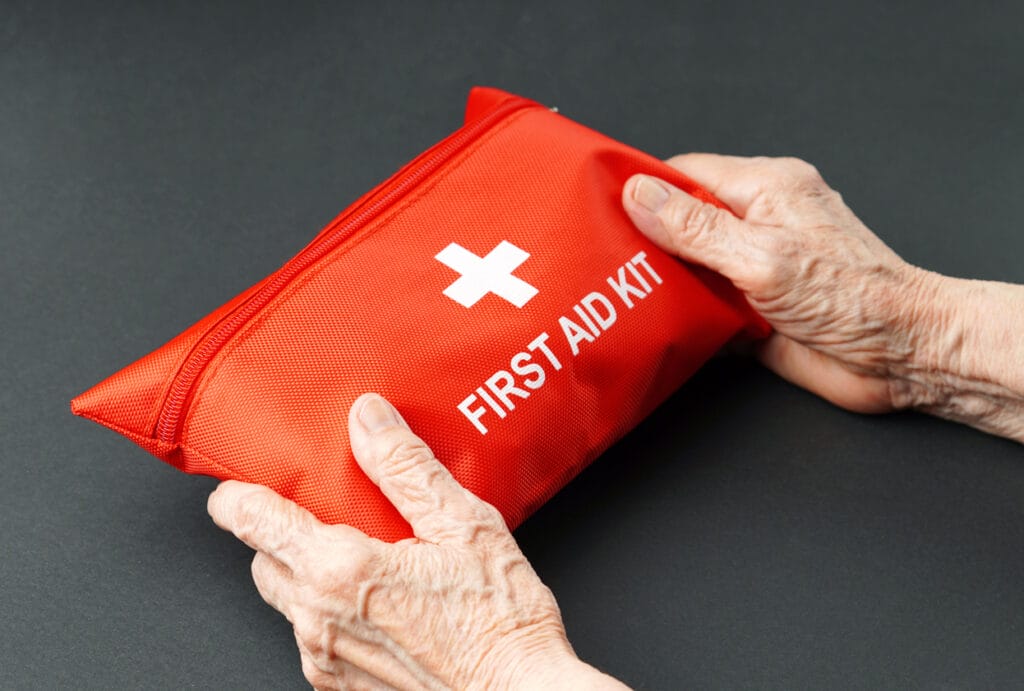 A senior man holding an emergency kit