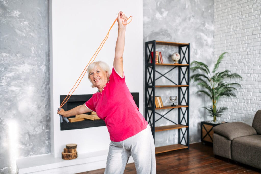 A woman doing senior-friendly physical activity at home