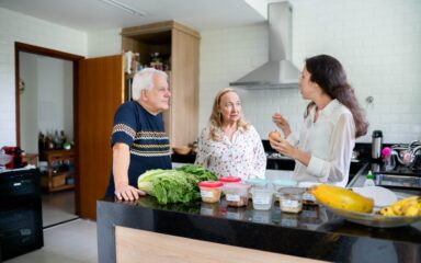 Nutritionist explaining meal plans with a senior couple during a diet consultation