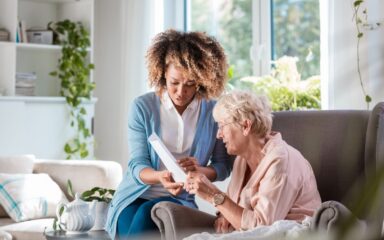 Home nurse taking care of senior woman
