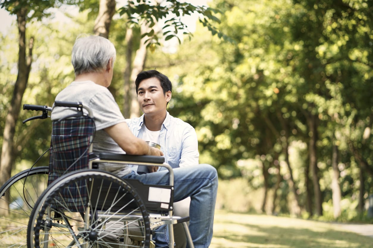 International Day of Charity: Supporting Seniors with Compassion. A young man shares a heartfelt moment outdoors with an elderly loved one in a wheelchair, symbolising empathy, understanding, and the importance of compassionate care. Assisted Living Locators celebrates the spirit of charity, encouraging support for seniors to ensure they feel valued and cared for.