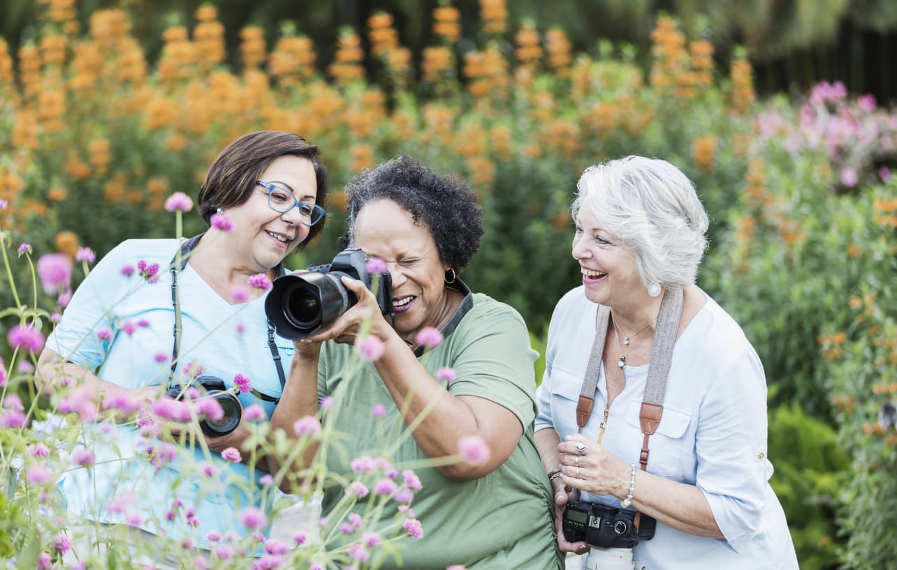 Lifelong Learning for Seniors. A group of joyful seniors embraces the art of photography in a colourful garden setting, capturing vibrant flowers and laughter as they explore a new skill together. Assisted Living Locators celebrates the importance of lifelong learning, encouraging seniors to pursue hobbies and educational activities that stimulate the mind, foster creativity, and enhance social connections.