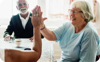 A woman in a senior living community receiving caring assistance from a caregiver